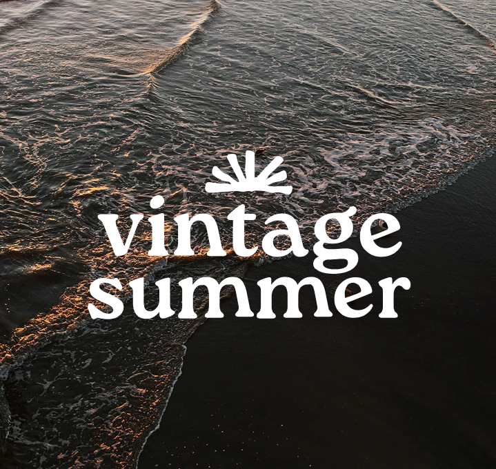 Бялото лого на Vintage Summer върху снимка на морски вълни